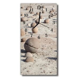 Sklenené hodiny vertikálne Zobraziť kamene na béžovej pláži